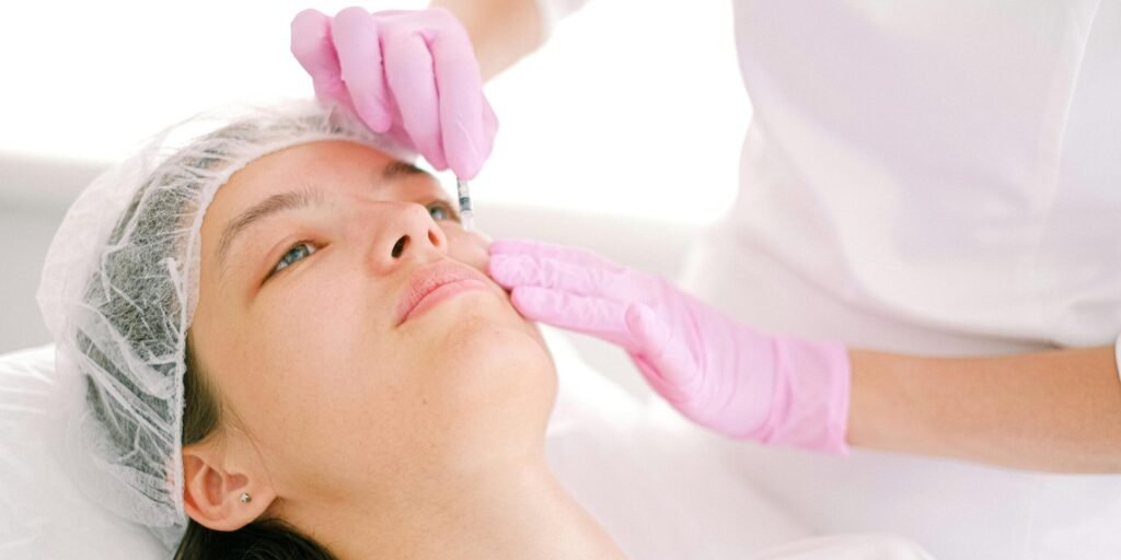 Woman receives cosmetic injection in clinical setting, enhancing beauty using modern techniques.